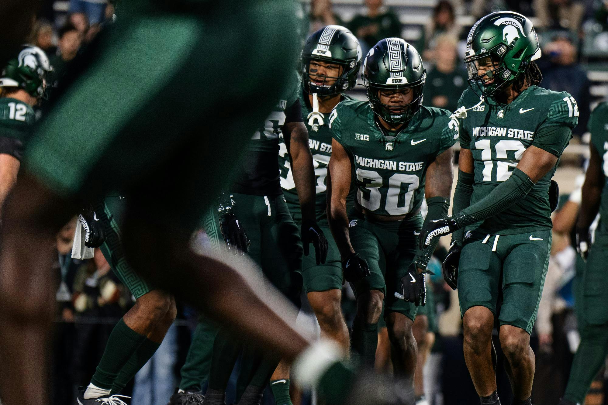 Michigan State freshman defensive back Justin Denson Jr. (12) laughs with teammate redshirt sophomore defensive back Aveon Grose (30) before the homecoming game against the University of Iowa at Spartan Stadium on Oct. 19, 2024.  The Spartans took victory over the Hawkeyes with a score of 32-20. 