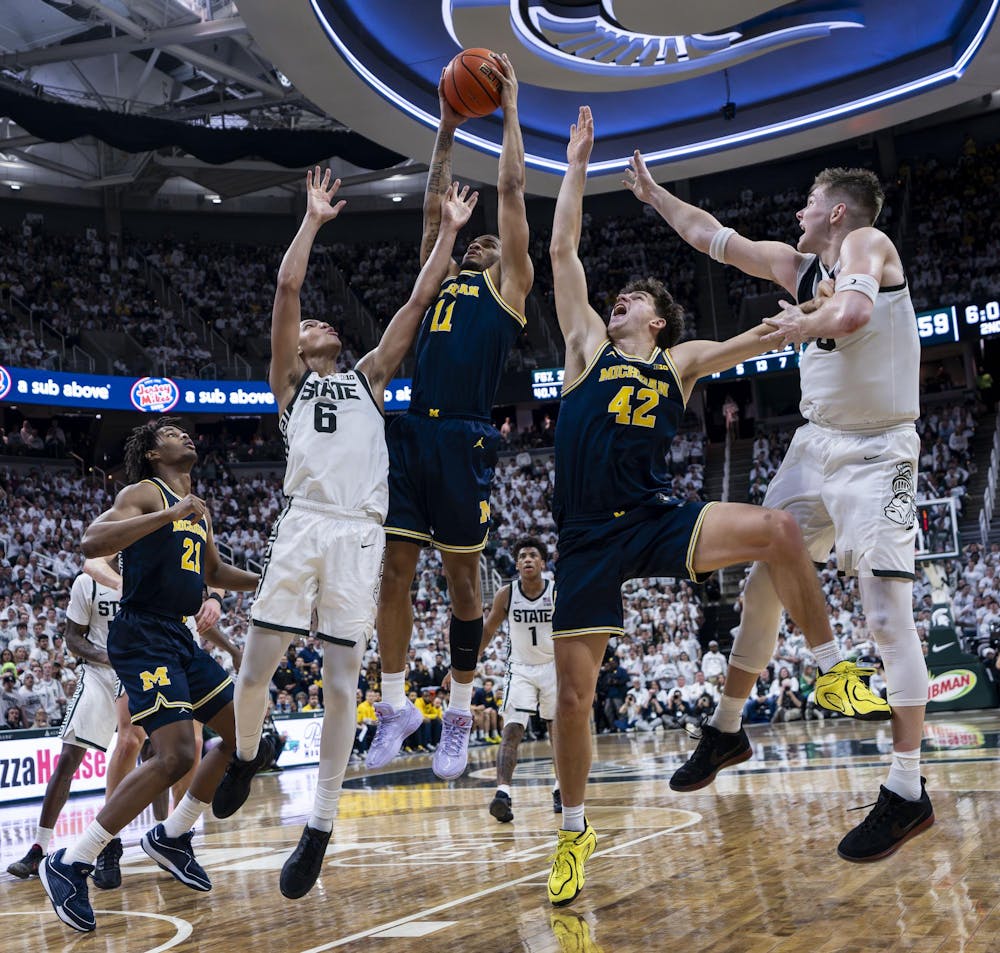 <p>UM senior guard Roddy Gayle Jr. (11) and graduate student forward Will Tschetter (42) and MSU freshman forward Jordan Scott (6) and senior forward Jaxon Kohler (0) reach for the ball after a free throw from MSU at the Breslin Student Events Center on Jan. 30, 2026.&nbsp;</p>