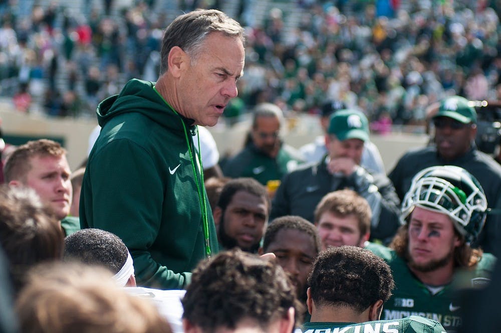 <p>Head coach Mark Dantonio talks to the team after the Green and White Spring game April 25, 2015, at Spartan Stadium. The white team defeated the green team, 9-3. Hannah Levy/The State News</p>