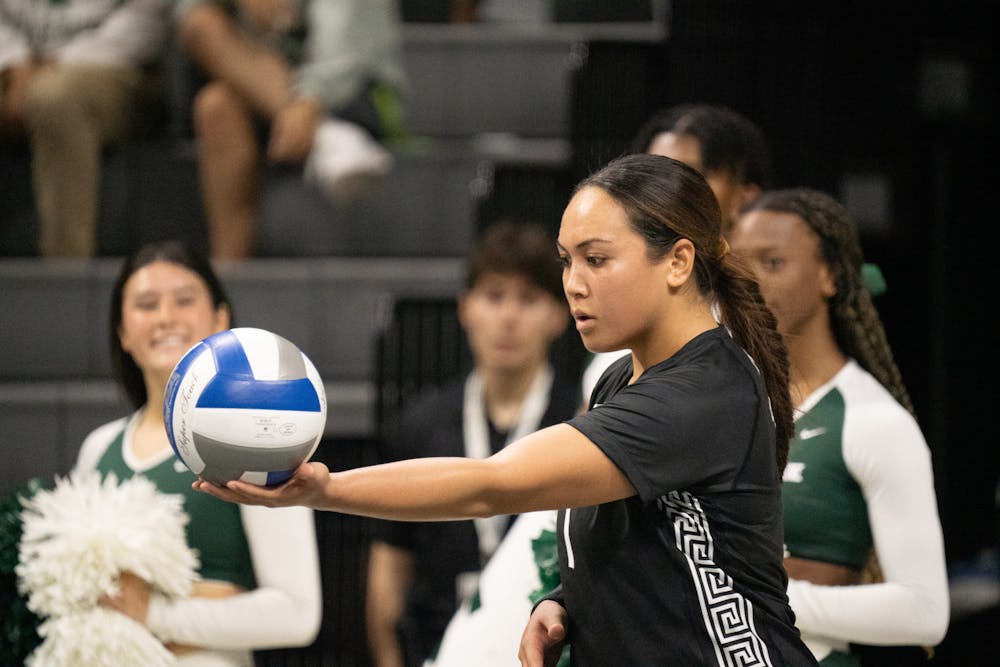 <p>Junior libero Nalani Iosia serving the ball at the Purdue vs. MSU game held at the Breslin Center on Nov. 4. The Spartans ultimately fell to the Boilermakers 3-1.</p>
