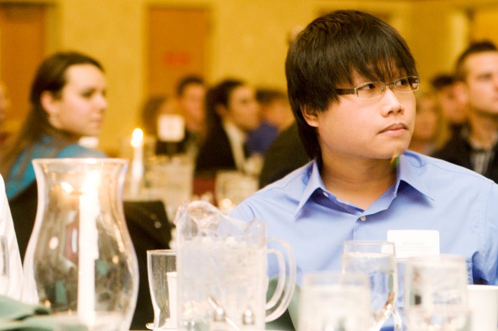 Supply chain junior An Nguyen listens as guest speakers talk about proper dining and dress etiquette Tuesday night in the Union Ballroom. Aaron Snyder/The State News. 