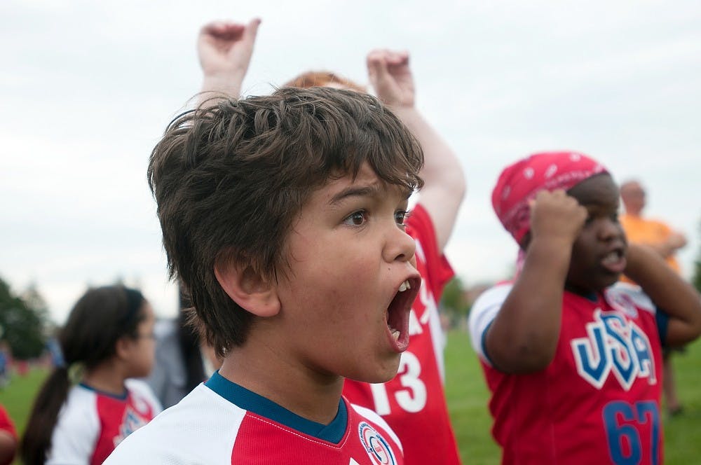 	<p>Jacob Contreras of Riverside, Calif., cheers after his team scores the winning goal Aug. 5, 2013, at Munn field during the World Dwarf Games. Contreras&#8217; team won in a penalty kick shootout. Weston Brooks/The State News</p>