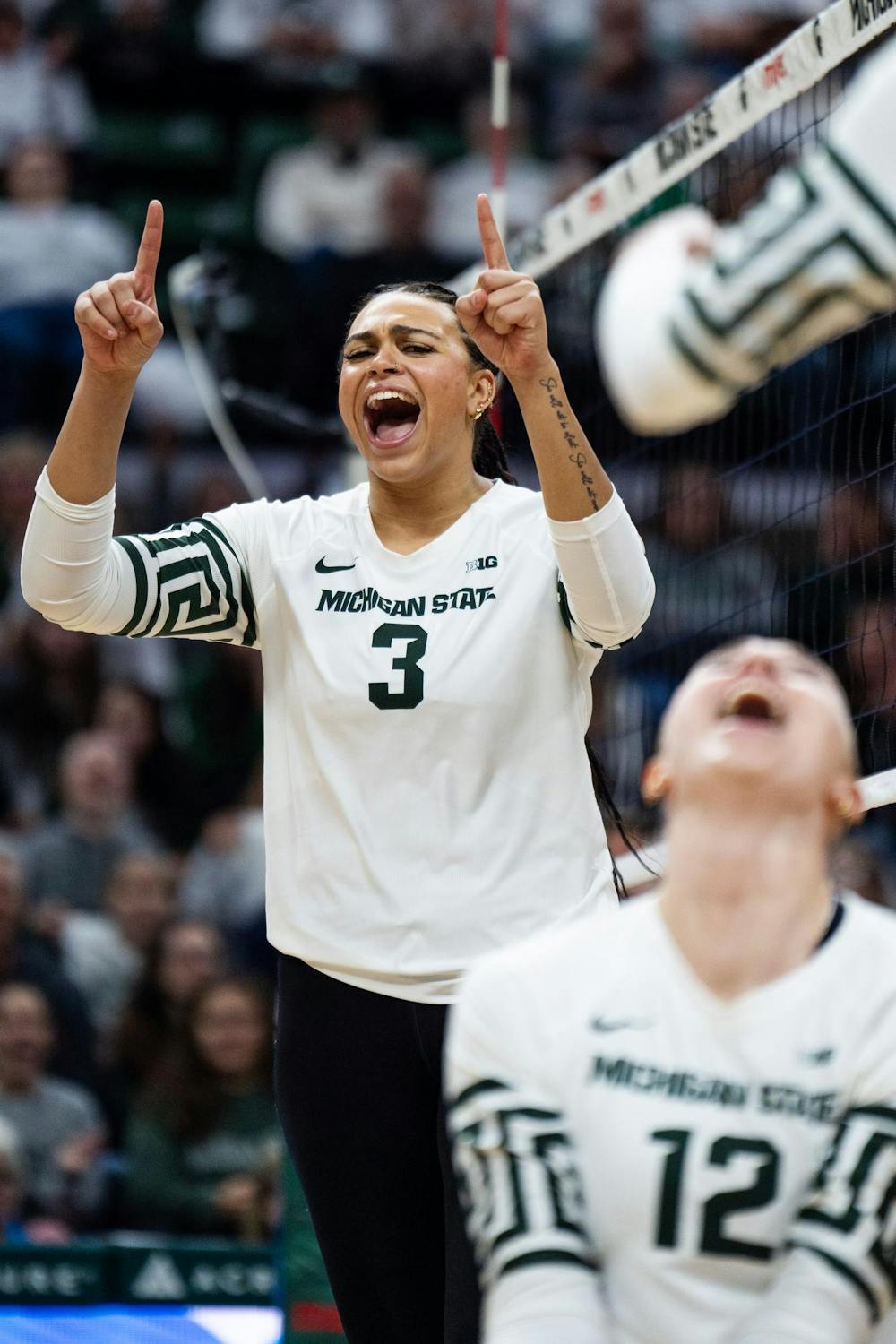 Michigan State junior outside hitter Akasha Anderson (3) and junior middle blocker Evie Doezema (12) celebrate a point against University of Michigan at the Breslin Center on Nov. 15, 2024.