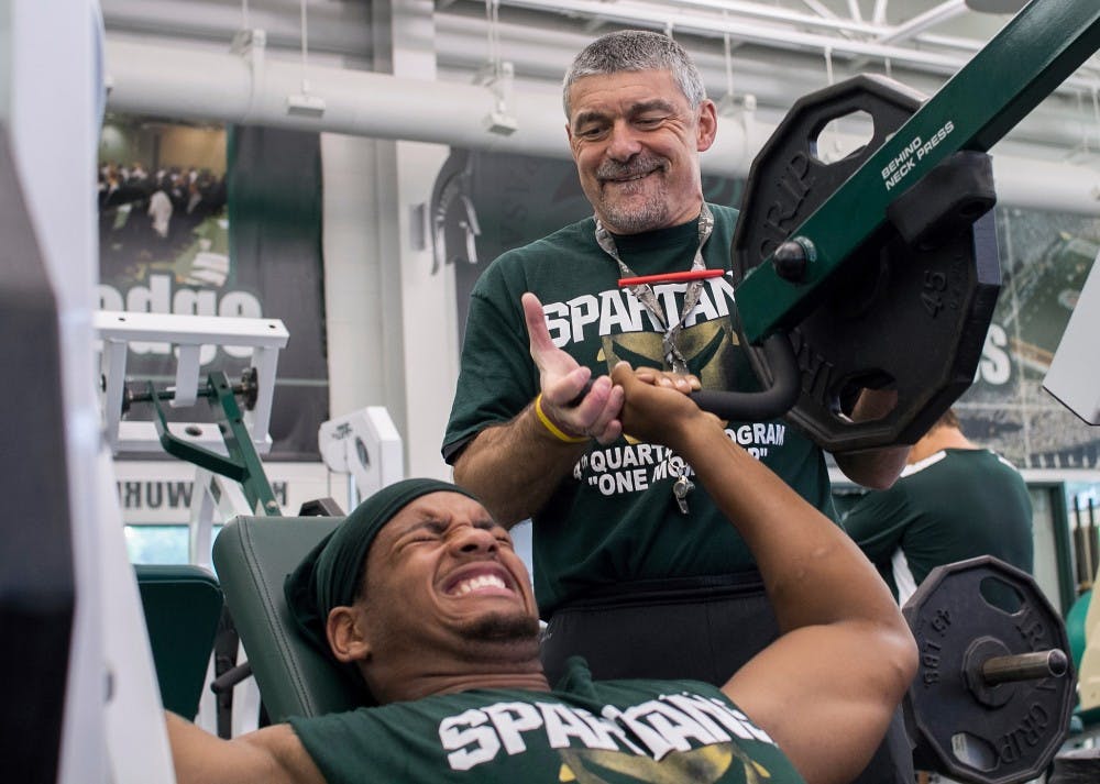 Ken Mannie, football's head strength and conditioning coach, works with junior defensive end William Gholston during a conditioning practice in the Duffy Daugherty Football building on Friday morning, July 13, 2012. Mannie is a working member of the board for the information-based Athletic Strength and Power (ASAP) website. Natalie Kolb/The State News