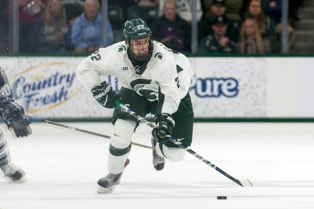 Senior forward JT Stenglein (22) skates the puck up ice during an exhibition game against the University of Toronto on Oct. 2, 2016 at Munn Ice Arena. The Spartans defeated the Blues 2-1 in an overtime shootout after ending regulation in a 2-2 tie. 
