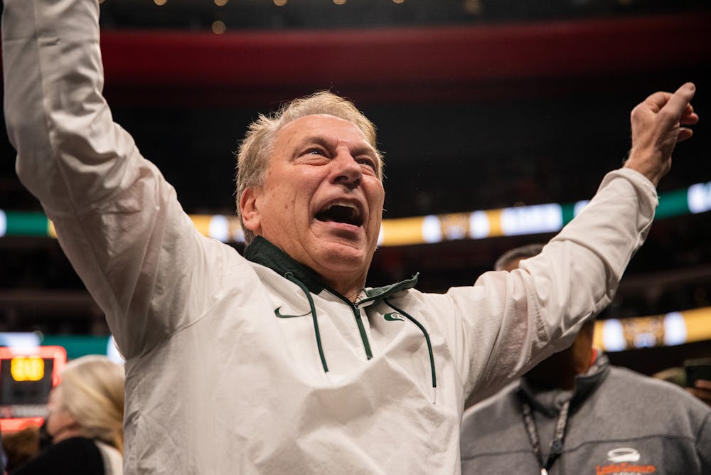 <p>Izzo cheers with fans as he makes his way out off the court after the Spartans win against the Oakland Golden Grizzlies at Little Caesars Arena on Tuesday, Dec. 21, 2021. </p>