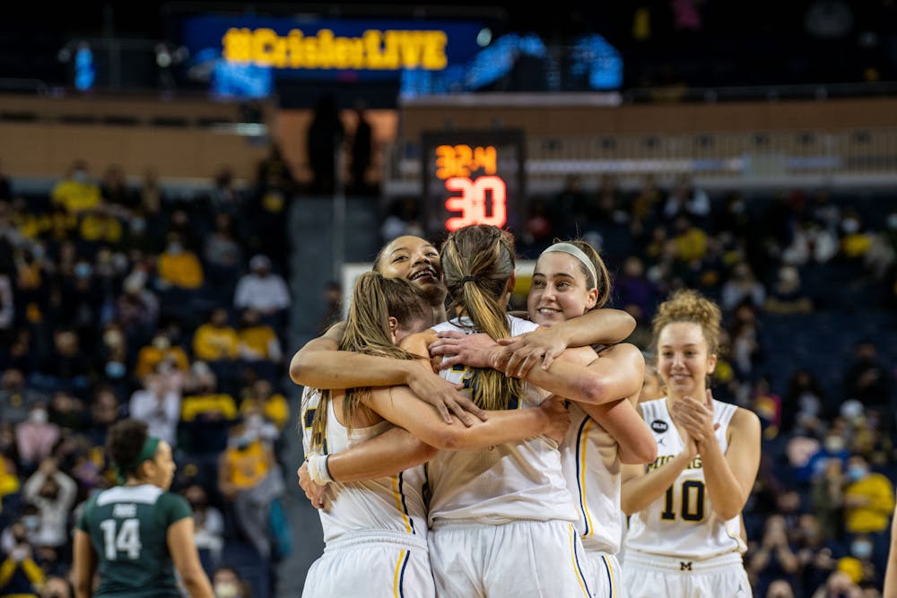 The Wolverine seniors embrace and celebrate the win tonight and their careers together. The Wolverines defeated the Spartans 62-51 at the Crisler Center on Feb 24., 22.