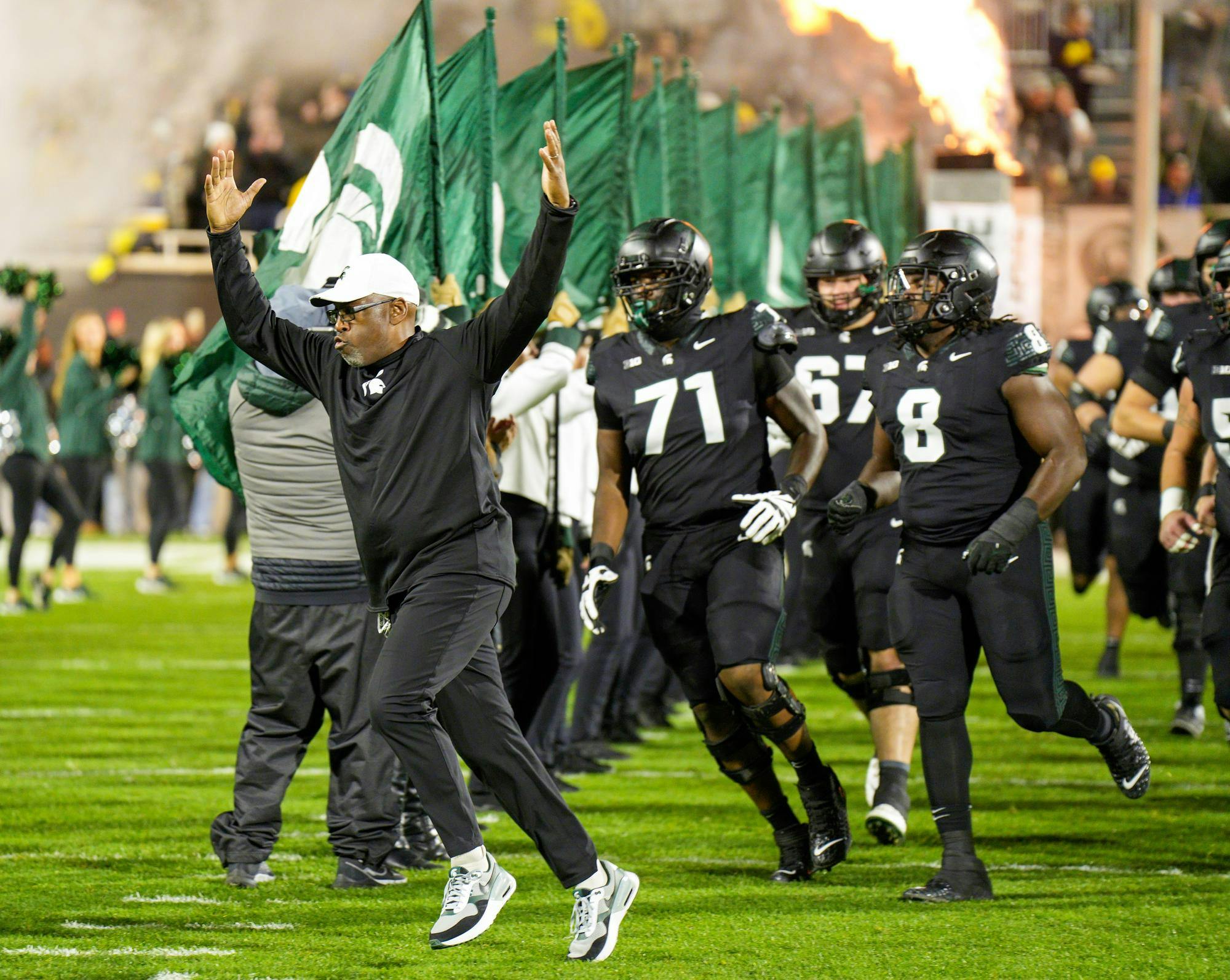 MSU Interim Head Coach Harlon Barnett leads his team onto the field prior to the start of their game against the University of Michigan on Oct. 21, 2023. The MSU Spartans would go on to lose 49-0.