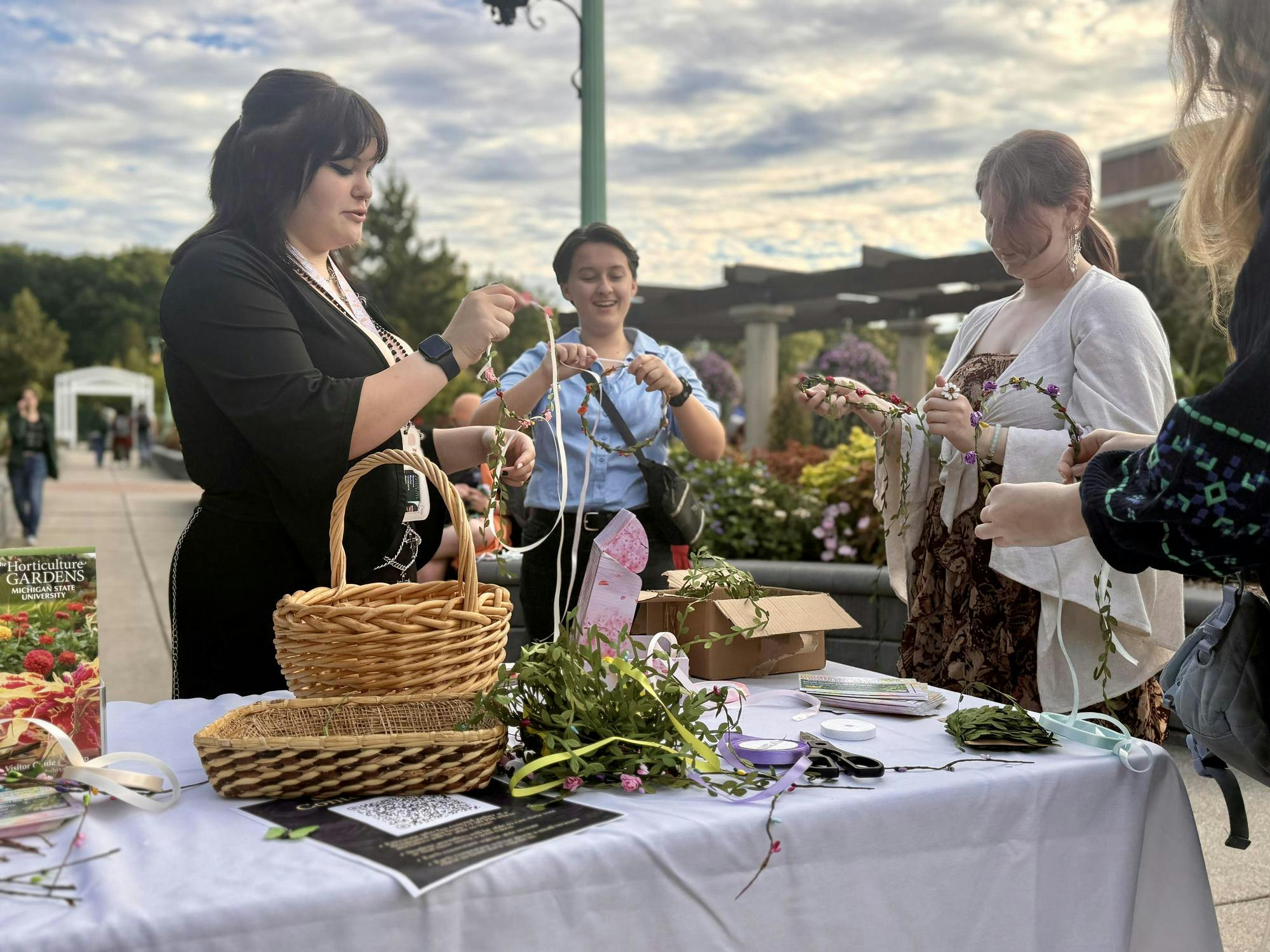 <p>Michigan State students craft crowns from plants and flowers in the Horticulture Garden in East Lansing, Mich., on Friday, Sept. 25, 2026.</p>