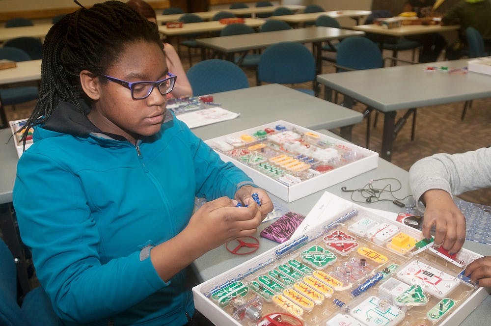 <p>Lansing resident Audai Demps, 14, works on a snap circuit on March 11, 2014, at East Lansing Public Library during Teen Tech Week. The event makes an effort to encourage teens to become involved with technology. Betsy Agosta/The State News</p>