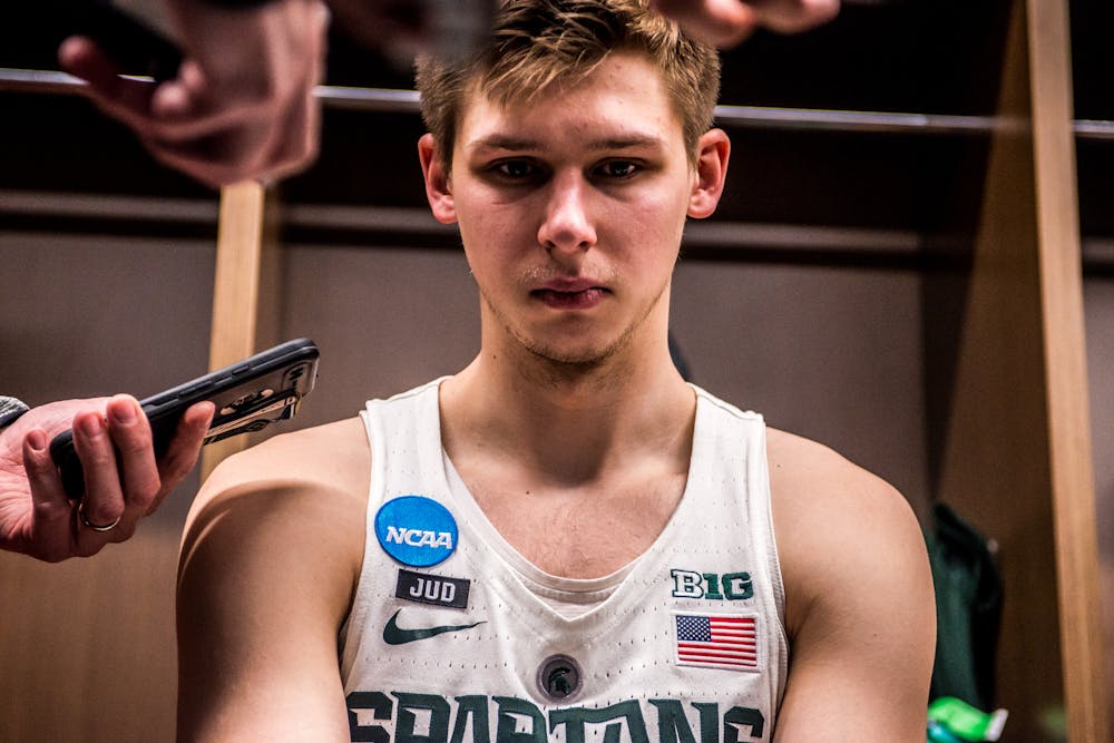 <p>Junior guard Matt McQuaid (20) answers questions from the media in the locker room after the game against Syracuse on March 18, 2018 at Little Caesars Arena in Detroit. The Spartans fell to the Orange, 55-53 ending their NCAA journey.&nbsp;</p>