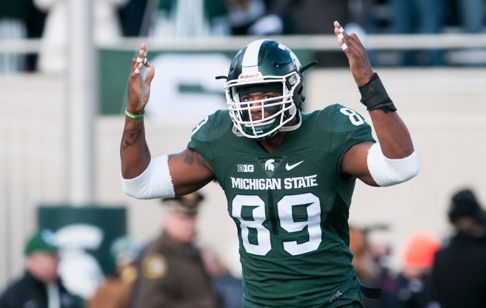 Senior defensive end Shilique Calhoun motions to the crowd prior to the game against Penn State on Nov. 28, 2015 at Spartan Stadium. The seniors who will be graduating this year and their families were honored as this was the last home game of the season.