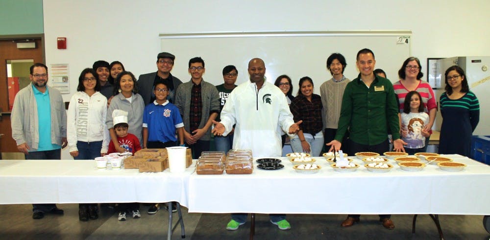 <p>Photo of past Thanksgiving Unity Day Dinner as students, adults and children come together to celebrate a traditional&nbsp;Thanksgiving dinner, Juan Flores is pictured far right wearing green shirt. Photo courtesy of Juan Flores.</p>