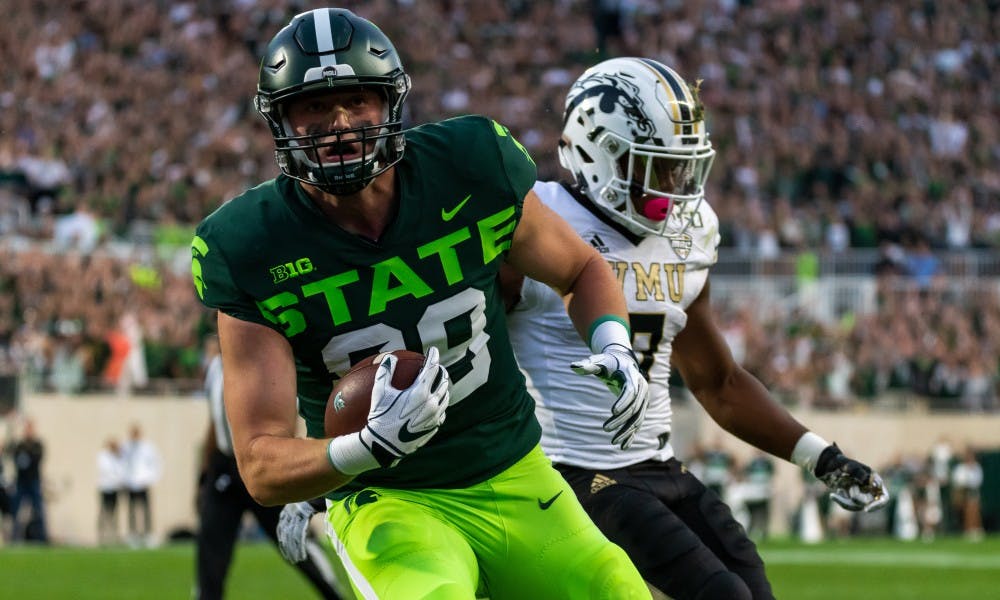 <p>Junior tight end Matt Dotson scores on a touchdown pass against Western Michigan. The Spartans defeated the Broncos, 51-17, on Sept. 7, 2019 at Spartan Stadium. </p>