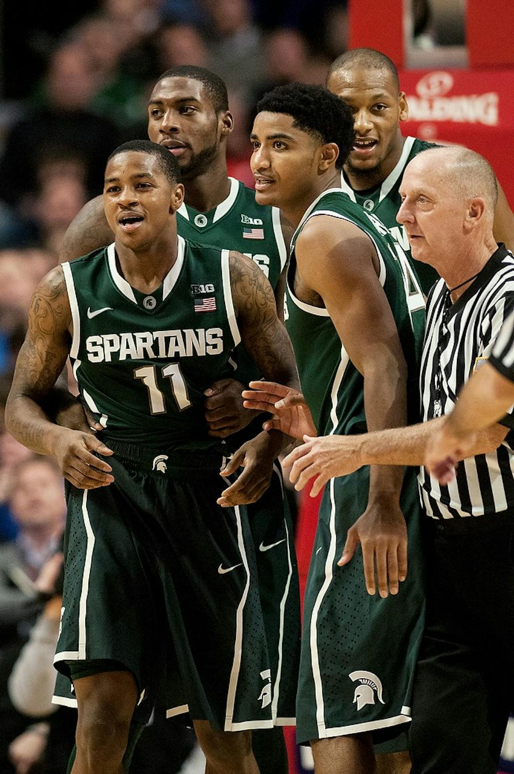 	<p>Senior guard Keith Appling gets picked up by his teammates after a fall during the game against Kentucky on Nov. 12, 2013, during the Champions Classic at The United Center in Chicago, IL. The Spartans defeated the Wildcats, 78-74. Khoa Nguyen/The State News</p>