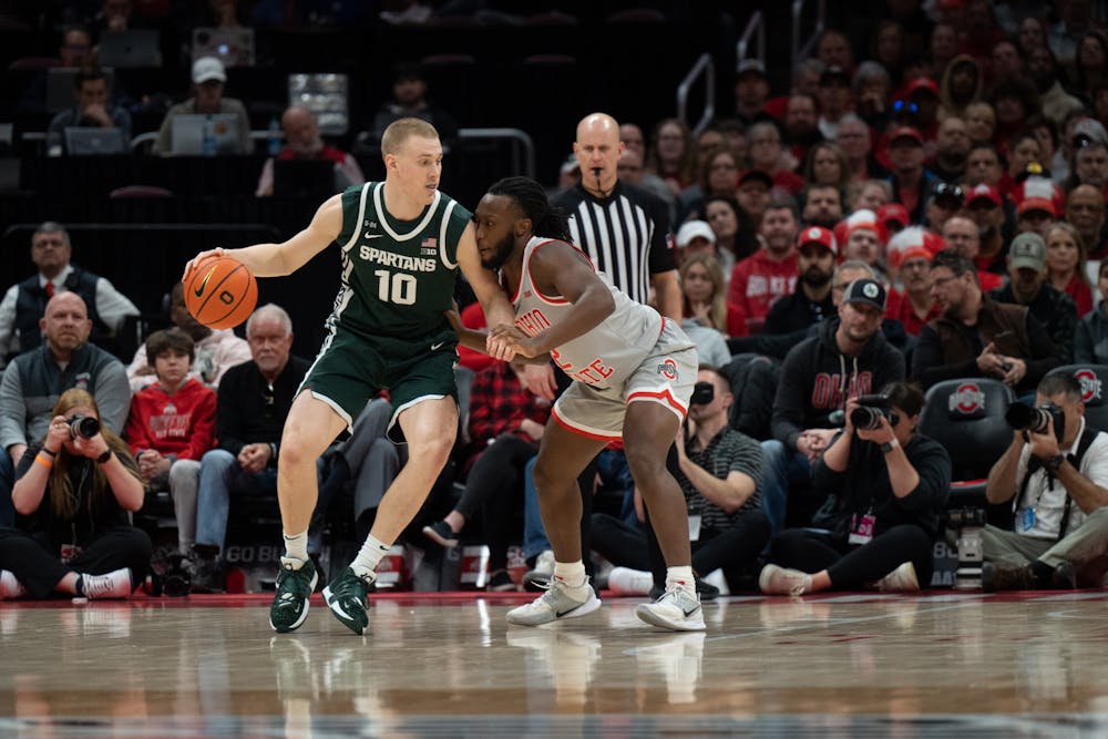 <p>Spartan forward Joey Hauser (left) attempts to drive past Buckeye guard Bruce Thornton at the Schottenstein Center in Columbus, Ohio on Sunday, Feb. 12, 2023. Hauser netted eight rebounds in addition to his 22 points during the Sunday afternoon matchup.</p>