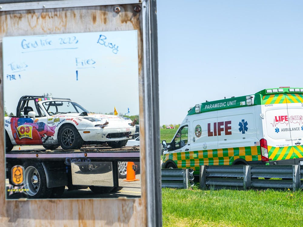 Sofa King Racing's Mazda Miata is loaded onto a flatbed trailer following car issues at the 24 Hours of Lemons race at Gingerman Race Track in South Haven, Michigan on May 10, 2025. 
