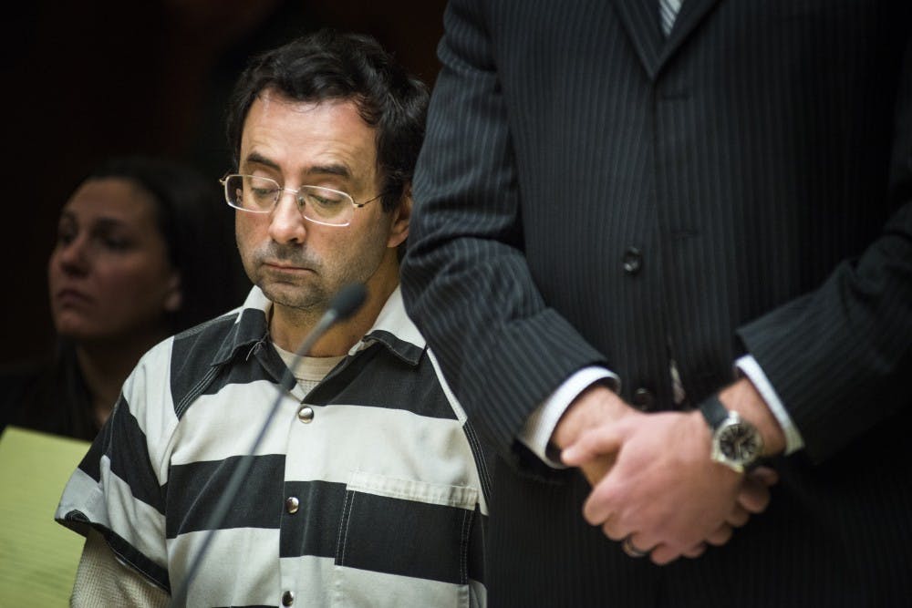 Former MSU employee Larry Nassar looks down before a pretrial hearing begins on Feb. 17, 2017 at 55th District Court in Mason, Mich. The hearing occurred as a result of former MSU employee Larry Nassar's alleged sexual abuse.