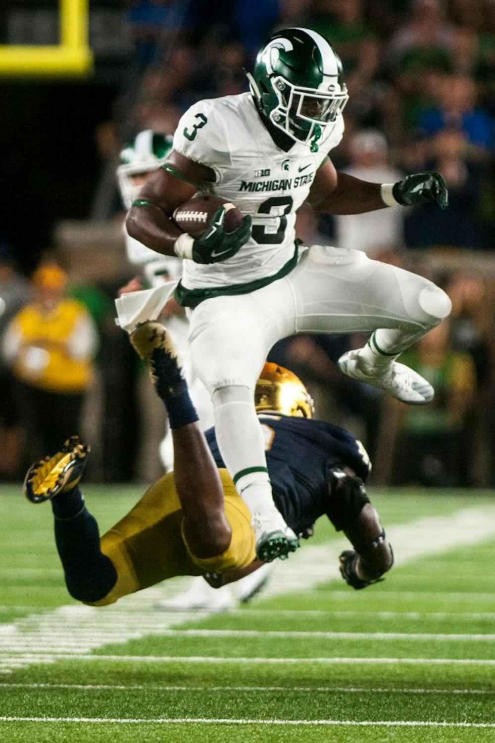 Sophomore running back LJ Scott (3) jumps over Notre Dame linebacker Nyles Morgan (5) during the game against Notre Dame on Sept. 17, 2016 at Notre Dame Stadium in South Bend, Ind.  The Spartans defeated the Fighting Irish, 36-28. 