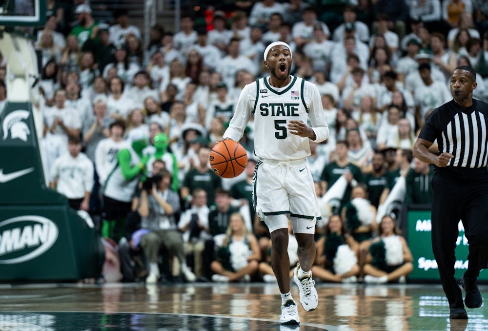 Freshman guard Tre Holloman (5) dribbles the ball during a game against Villanova at the Breslin Center on Nov. 18, 2022. The Spartans defeated the Wildcats 73-71. 