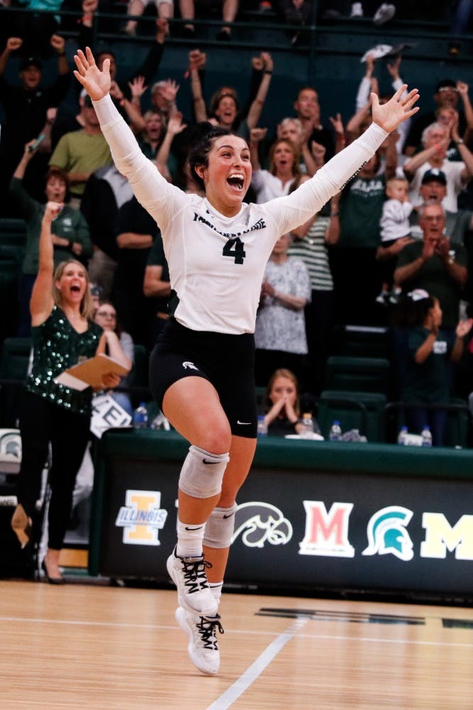 <p>Junior libero Jamye Cox (4) celebrates winning a set during the game against Cincinnati on Sept. 6, 2019, at Jenison Fieldhouse. The Spartans defeated the Bearcats, 3-1.</p>