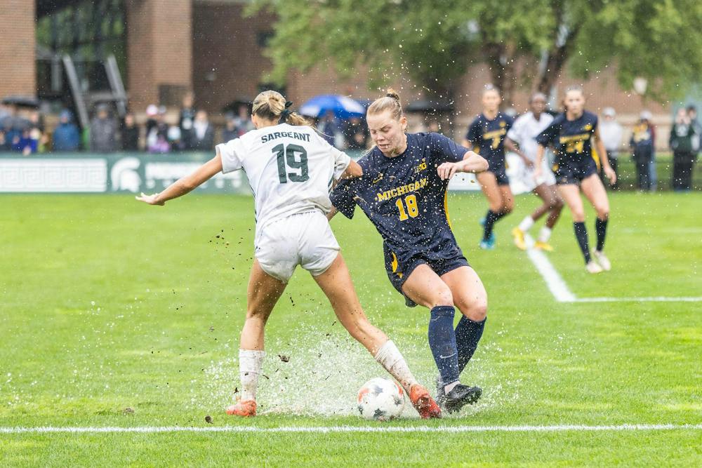 <p>Muddy conditions severely impact the play between MSU senior midfielder Emerson Sargeant (19) and Michigan freshman defender Torah Betteridge (18) as rain continues to pour down at DeMartin Stadium in East Lansing, Mich., on Sept. 20, 2026.</p>