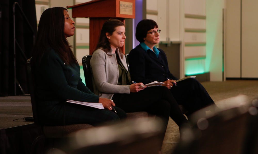 <p>From left to right, Trustees Brianna T. Scott, Kelly Tebay and Dianne Byrum listen to community members during a town hall meeting on March 18, 2019, at the Kellogg Center.</p>
