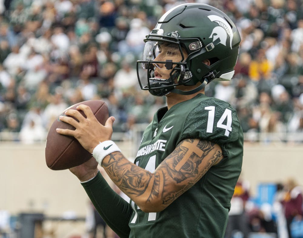 <p>Redshirt sophomore quarterback Noah Kim, 14, warms up during Michigan State’s match against Minnesota on Saturday, Sept. 24, 2022. The Gophers ultimately beat the Spartans, 34-7.</p>