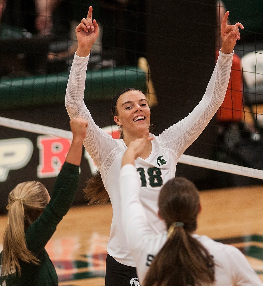 <p>Freshman outside hitter Holly Toliver celebrates with her teammates after scoring a point Sept. 6, 2014, at Jenison Fieldhouse during a game against Duke University. The Blue Devils defeated the Spartans, 3-2. Aerika Williams/The State News</p>