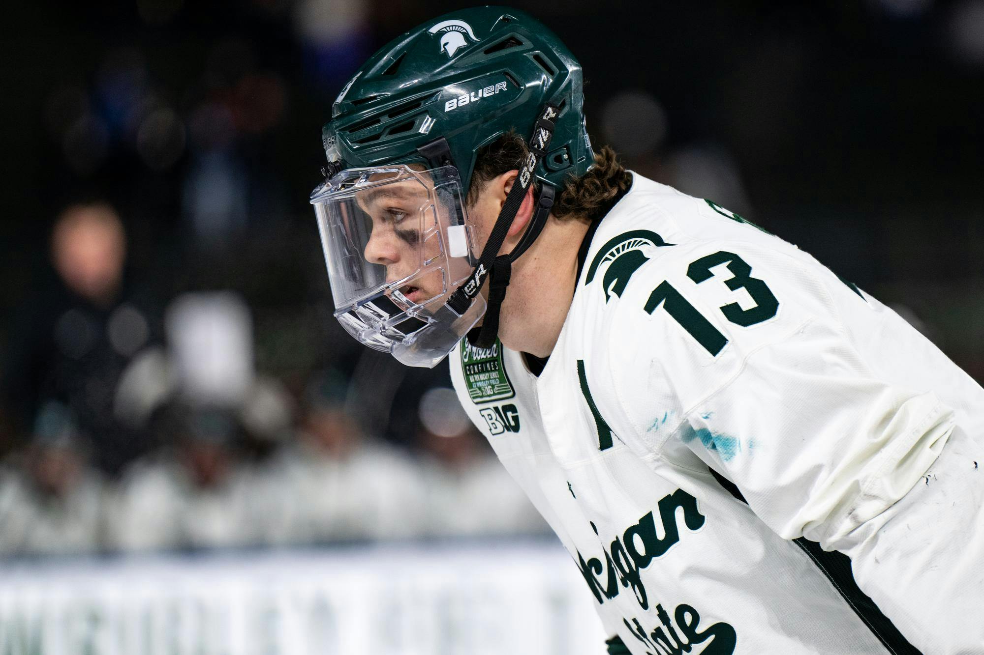 Michigan State junior forward Tiernan Shoudy (13) readies himself for a faceoff at Wrigley Field in Chicago on Jan. 4, 2025. The Spartans' junior forward Daniel Russell (20) netted the overtime winner with under two seconds remaining, earning the weekend sweep over the Badgers.