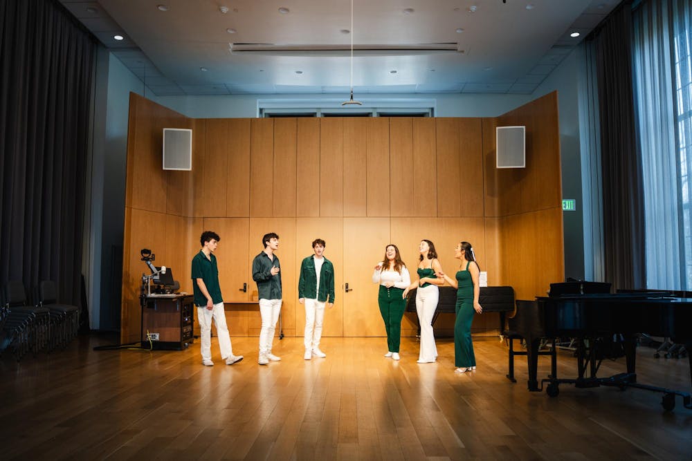 <p>Members of the Capital Green A Capella board showcase a portion of their ICCA set inside the college of music on March 25, 2024.</p>