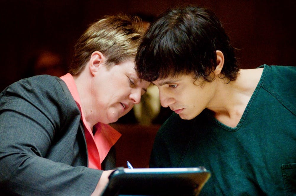 	<p>Alleged dog killer and graduate student Andrew Thompson talks with his attorney Kimberly Savage Thursday morning at the 55th District Court. Thompson will face 13 counts of animal killing in circut court and is currently being held in the Ingham County Jail on a $1 million bond. </p>