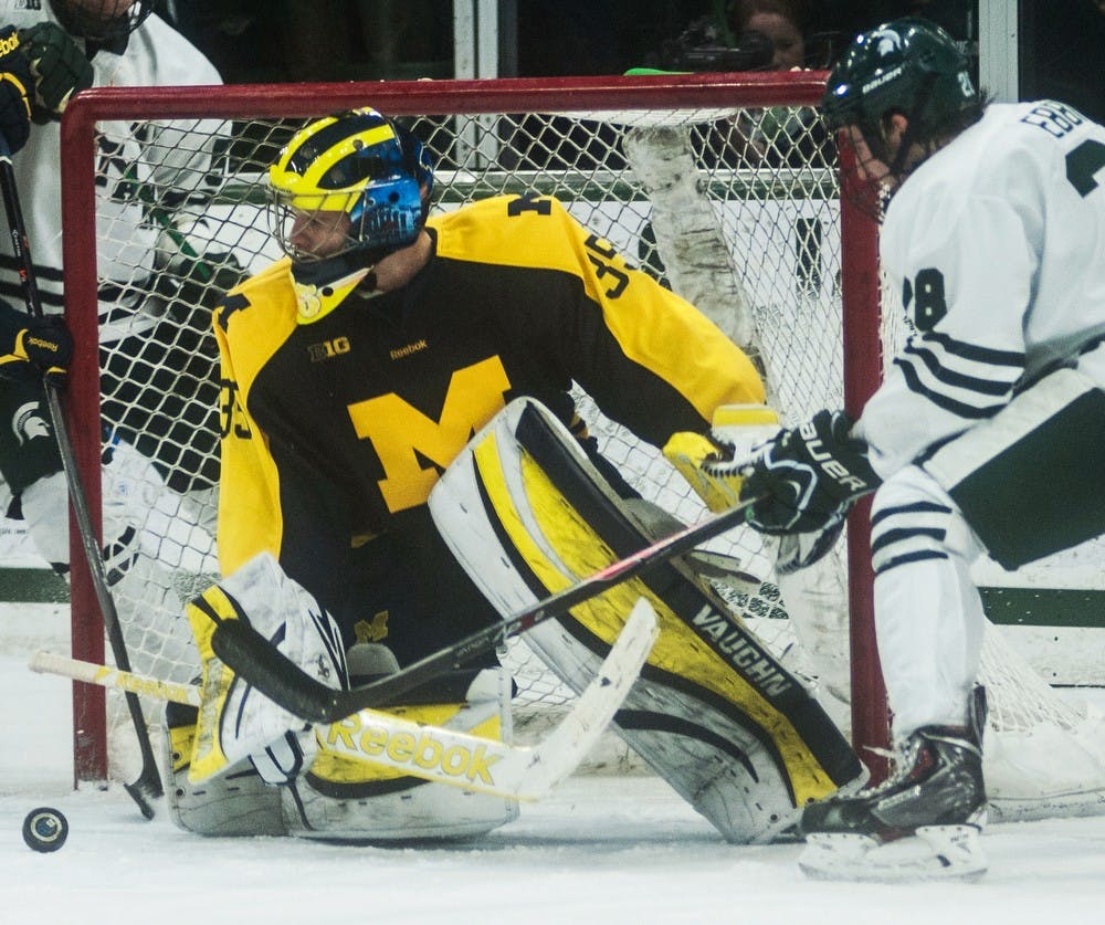 	<p>Freshman forward Thomas Ebbing attempts to score a goal as Michigan goaltender Zach Nagelvoort guards the net Jan. 24, 2014, at Munn Ice Arena. The Wolverines defeated the Spartans, 5-2. Erin Hampton/The State News</p>