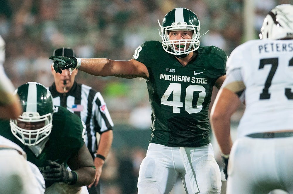 	<p>Senior linebacker Max Bullough directs teammates before a snap during the game against Western Michigan on Aug. 30, 2013, at Spartan Stadium. The Spartans defeated the Broncos, 26-13. Danyelle Morrow/The State News</p>