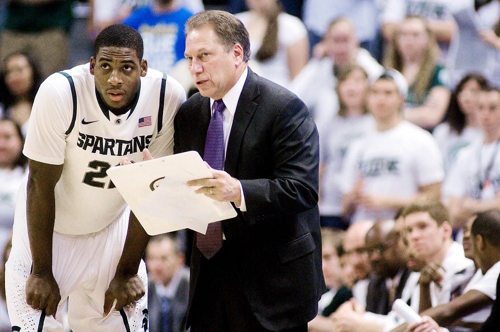 Head coach Tom Izzo talks with then-freshman guard Branden Dawson in between plays on Dec. 12, 2011 at Breslin Center. State News File Photo