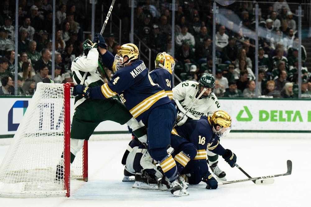 <p>Notre Dame junior defender Michael Mastrodomenico (4) pushes Michigan State junior right wing Daniel Russell (20) from the front of the net at Munn Ice Arena on March 15, 2025. The Spartans took a 1-0 victory over the Fighting Irish, advancing to the Big Ten Championship.</p>