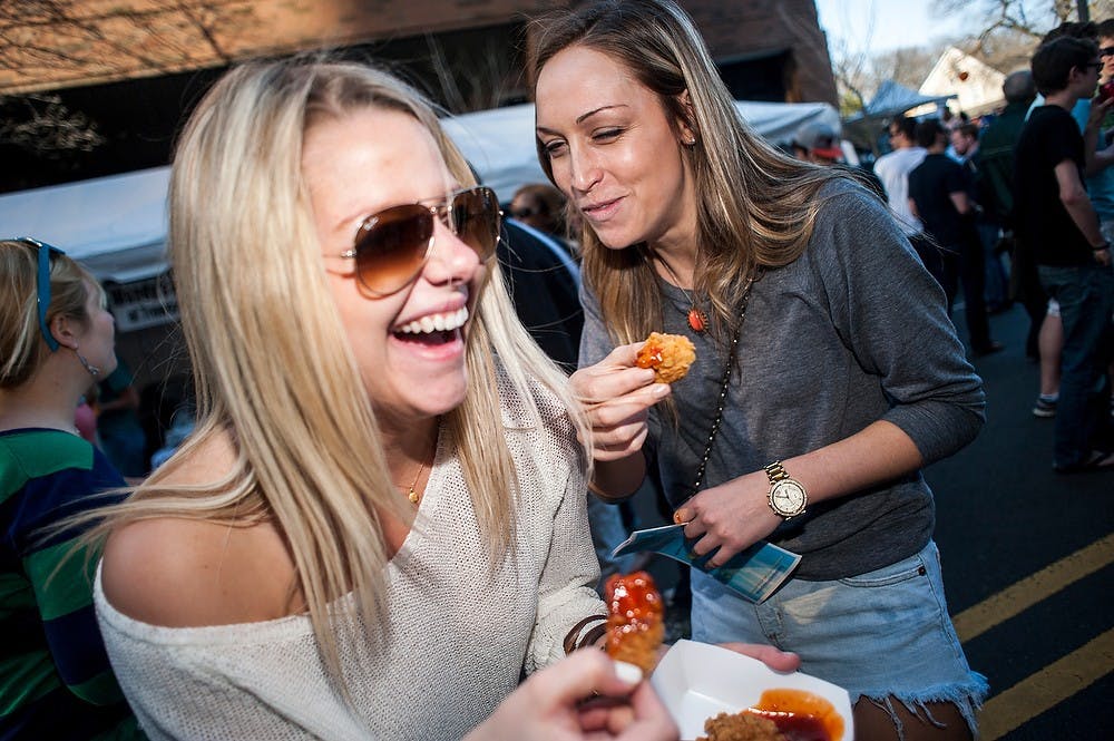	<p>Political science senior Michelle Kolkmeyer, left, and psychology senior Chelsea Kneip share a laugh as hundreds of residents crowded the 300 block of Albert Avenue, Saturday, April 27, 2013, during Taste of East Lansing. Justin Wan/The State News</p>