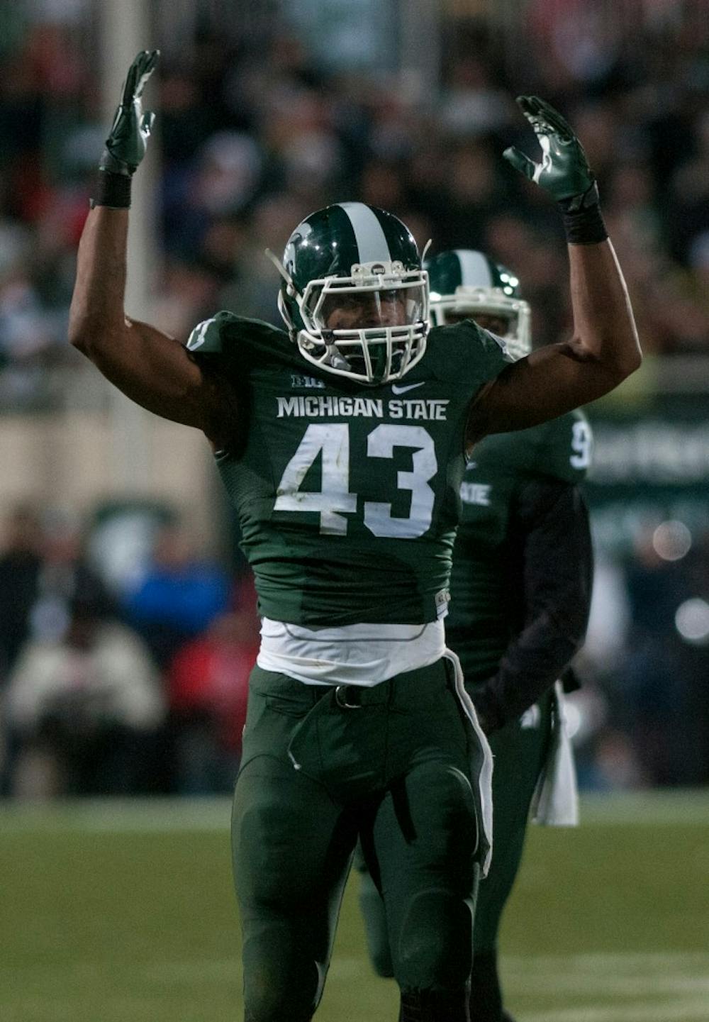 <p>Junior linebacker Ed Davis makes a gesture to get the crowd pumped before a play during the game against Ohio State on Nov. 8, 2014, at Spartan Stadium. The Spartans were defeated by the Buckeyes, 49-37. Raymond Williams/The State News</p>