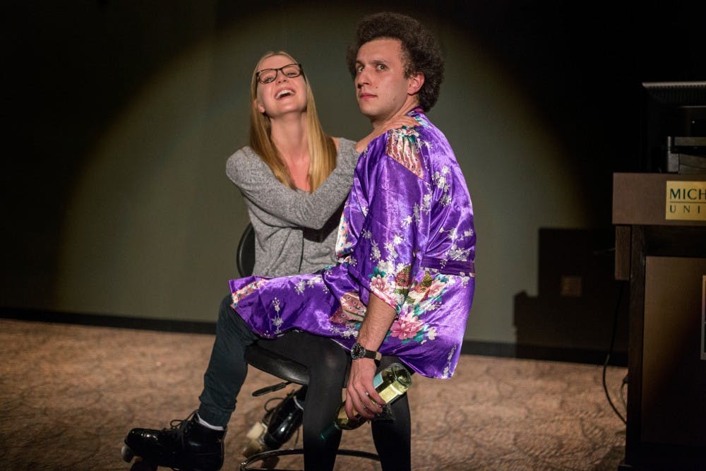 Former Michigan State student Sam Silverstein performs with a volunteer from the audience during the Laughter is the Cure event on March 29, 2017 at 632 Bogue St. in East Lansing. Laughter is the Cure raises money for kids with cancer through comedy shows performed by Sam Silverstein and Nick Tenaglia. 