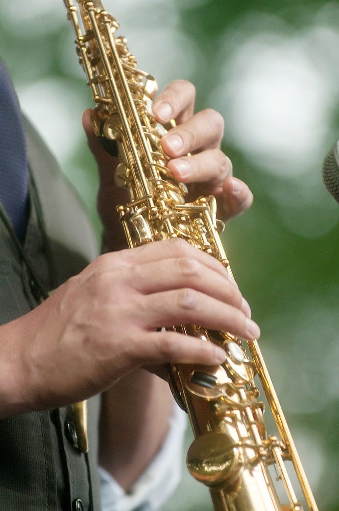 <p>Diego Rivera, MSU professor of jazz, plays the soprano sax on Aug. 2, 2013, during the Lansing JazzFest. Rivera has been playing for 25 years now. Weston Brooks/The State News</p>