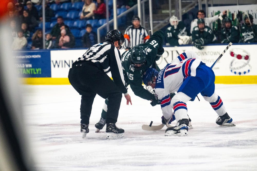 <p>Michigan State junior forward Charlie Stramel (15) takes a face-off against the under-18 U.S. Men's National Team Development Program's forward Cole McKinney (11) at USA Hockey Arena in Plymouth, Michigan on Nov. 21, 2024. In front of a sold out crowd, the Spartans captured a convincing 6-2 victory, showcasing why they deserve their ranking of number two in the nation.</p>