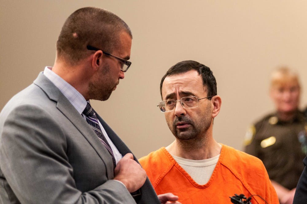 <p>Larry Nassar speaks with his attorney Matt Newburg during the plea hearing on Nov. 22, 2017, at the Veterans Memorial Court at 313 W Kalamazoo St., Lansing. Nassar pleaded guilty to seven counts.</p>