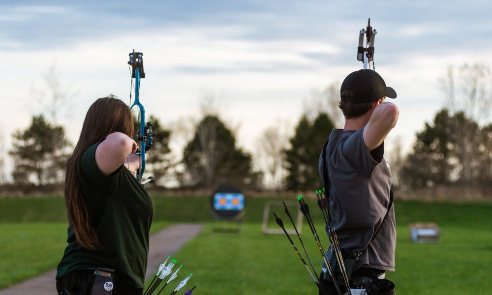 Political science junior Amber Arbegast (left) and advertising management sophomore Nick Massey shoot at the Demmer Shooting Center on April 22, 2019.