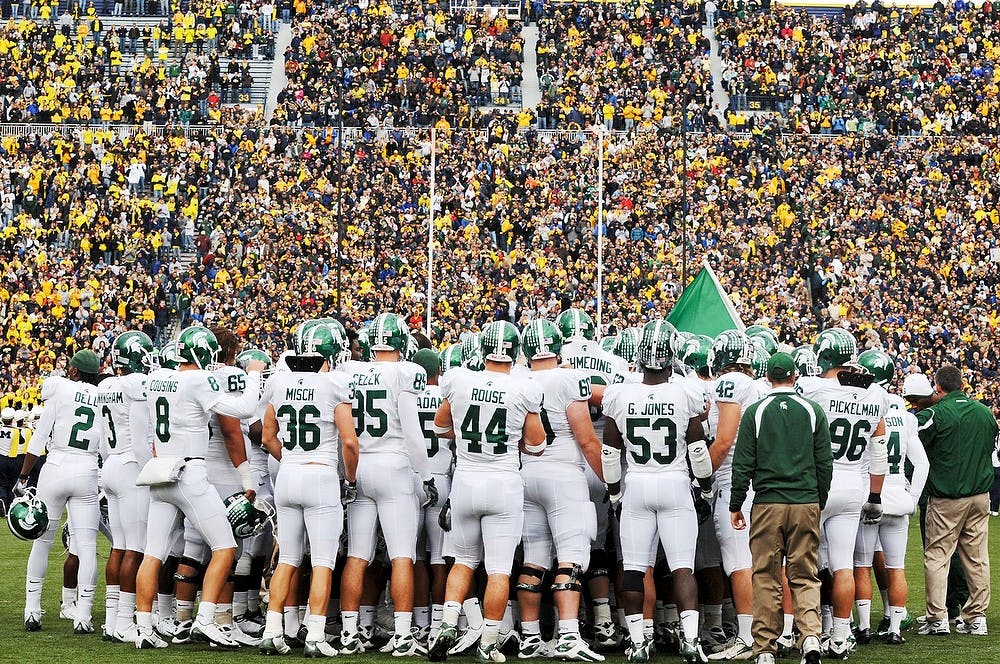 	<p>Michigan State players huddle together before defeating the Wolverines, 35-21, in Ann Arbor.</p>