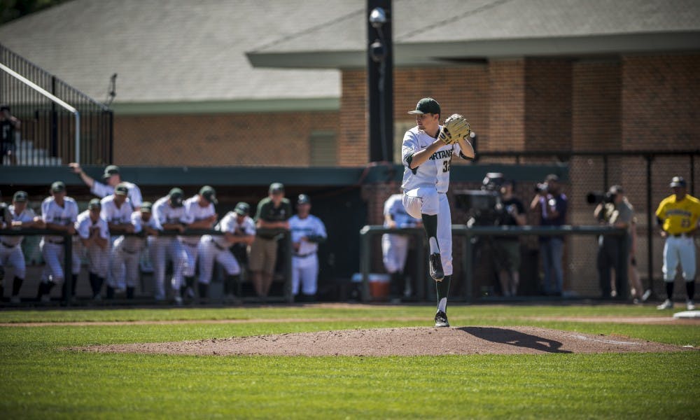 <p>Sophomore left-handed pitcher Alex Troop (32) winds up to throw a pitch during the the game against the University of Michigan on May 18, 2017 at McLane Baseball Stadium at Kobs Field. The Spartans defeated the Wolverines, 6-1.</p>