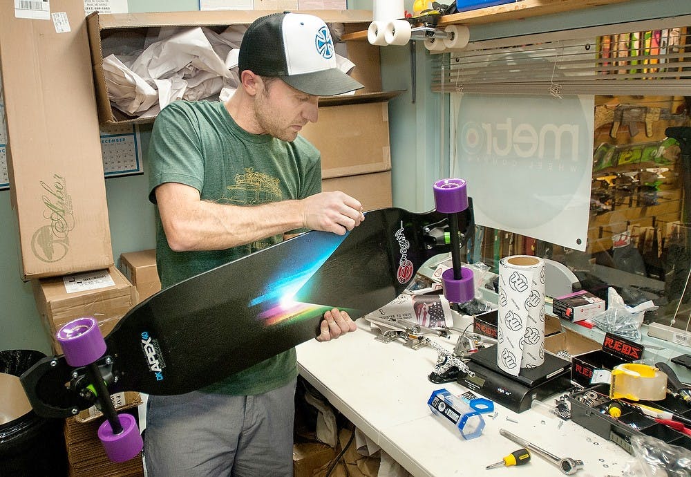 	<p>Jim MacGregor, owner of Action Board Sports, puts the finishing touches on a longboard on Tuesday, Oct. 16, 2012, at Action Board Sports. MacGregor, and <span class="caps">MSU</span> alumni, opened the shop in Oct. 2011. James Ristau/The State News</p>