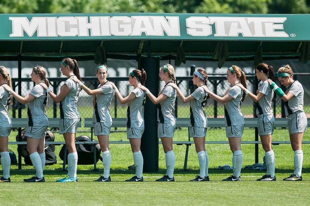 	<p>Spartan players stand for the national anthem before their game against Milwaukee, Aug. 25, 2013, at DeMartin Soccer Stadium. The Spartans defeated Milwaukee, 5-2. Danyelle Morrow/The State News</p>