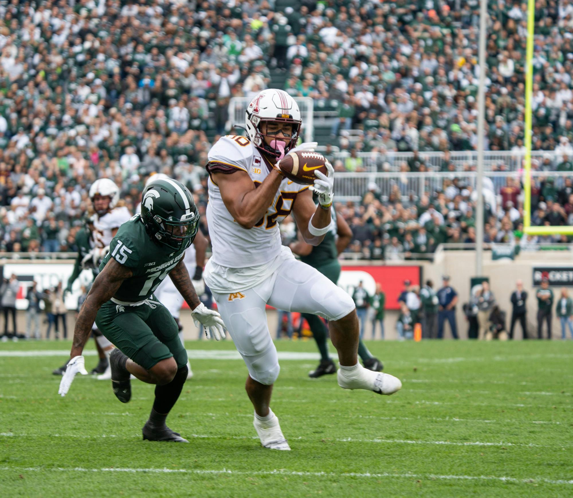 <p>Minnesota's redshirt senior Brevyn Spann-Ford (88) avoids a tackle by Michigan State's Angelo Grose on Sept. 24, 2022.</p>