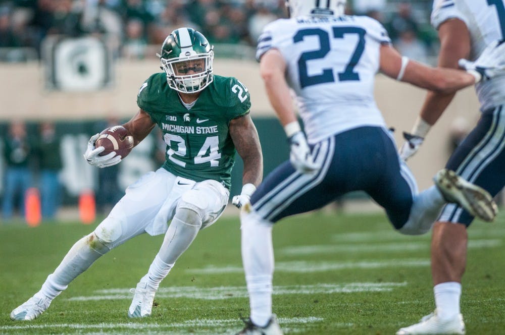 Junior running back Gerald Holmes (24) runs the football during the game against Brigham Young University on Oct. 8, 2016 at Spartan Stadium. Holmes rushed for a total of 58 yards. 