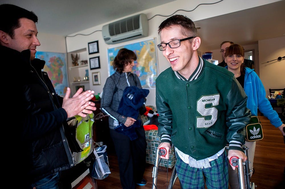 	<p>Rehabilitation counseling graduate student Piotr Pasik, center right, shares a laugh with his family members at his apartment, April 6, 2013, at Spartan Village. Pasik grew up with cerebral palsy, which limits his mobility; and if remained inactive, his muscles would easily get fatigued. Pasik has remained active, and has been playing on most of the games at the intramural soccer hosted by their recreational sports and fitness services at <span class="caps">MSU</span> since around 2004. Justin Wan/The State News </p>
